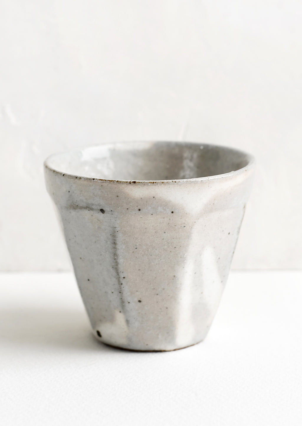 1: Small ceramic cups with faceted design.