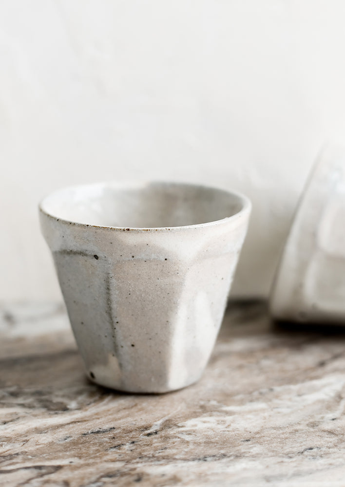 Small ceramic cups with faceted design.