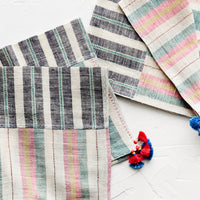 1: A pair of khadi cotton madras napkins with tassel detailing.