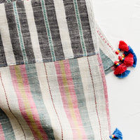 2: A khadi cotton madras napkin with tassel detailing.