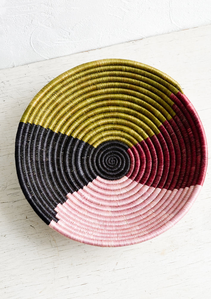 A round sweetgrass bowl in four color design.