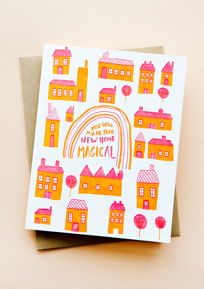 1: Greeting card with pink and orange houses, text at center reads "You Will Make Your New Home Magical".