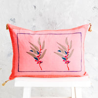 1: Decorative throw pillow in vibrant pink linen with block printed floral detail and jute tassels at corners