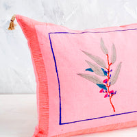 2: Decorative throw pillow in vibrant pink linen with block printed floral detail and jute tassels at corners