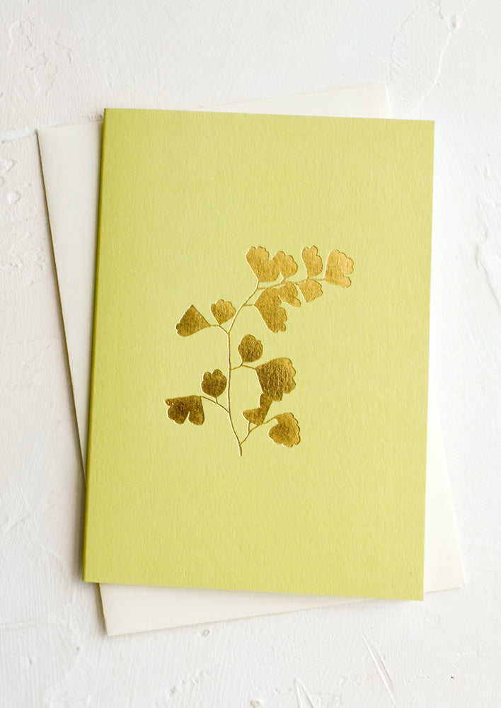 Green greeting card with gold imprint of maidenhair fern frond.