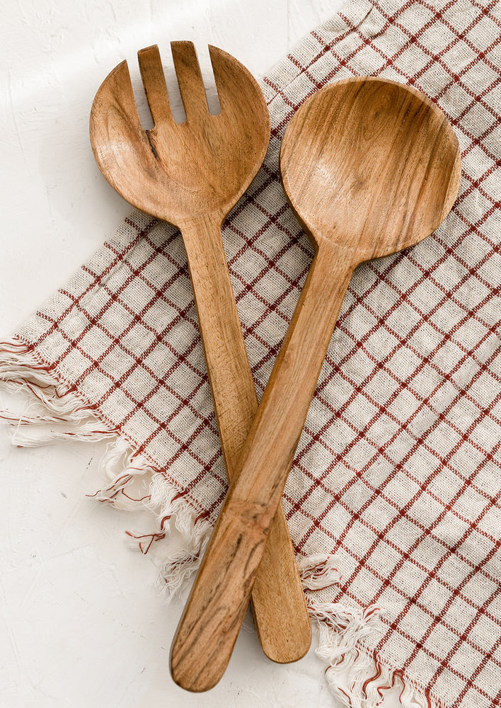 A pair of acacia wood salad servers with simple, plain design.