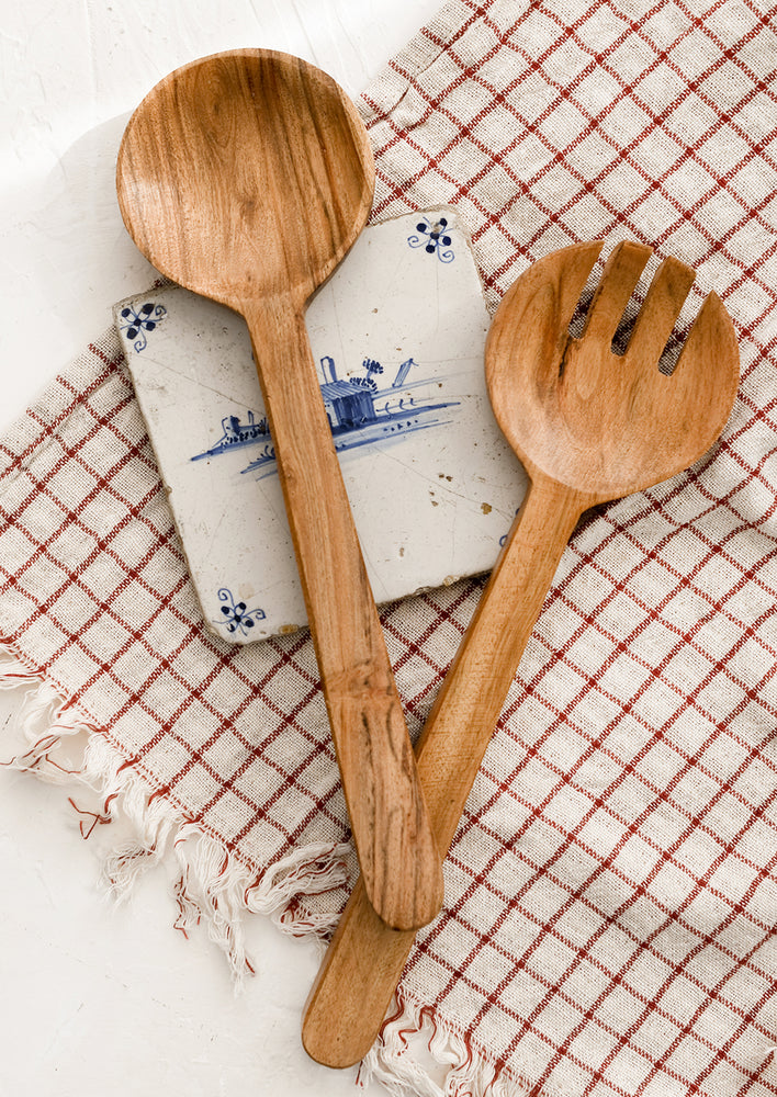 A pair of acacia wood salad servers with simple, plain design.