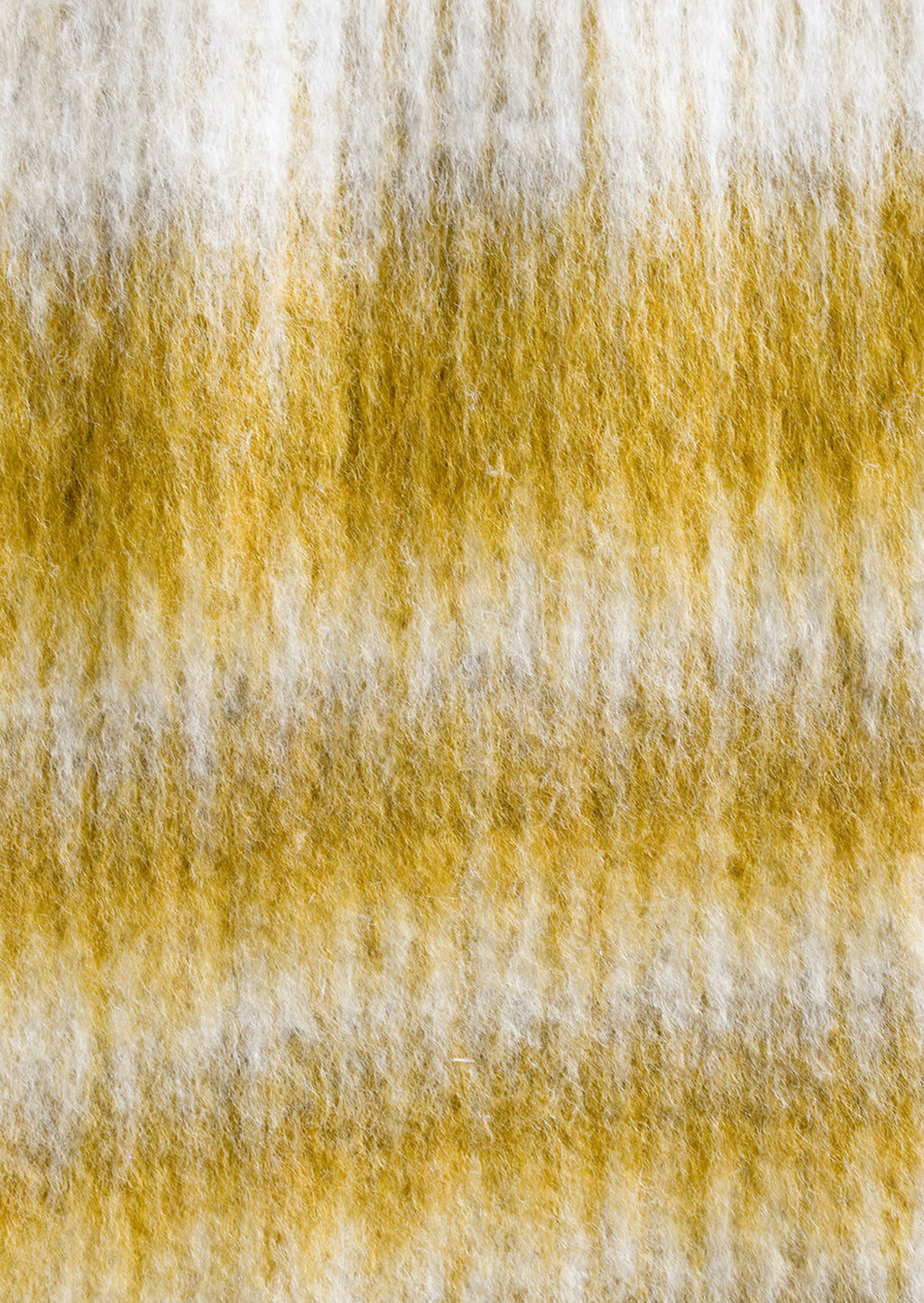 3: A mohair throw blanket in mustard and ivory stripe.