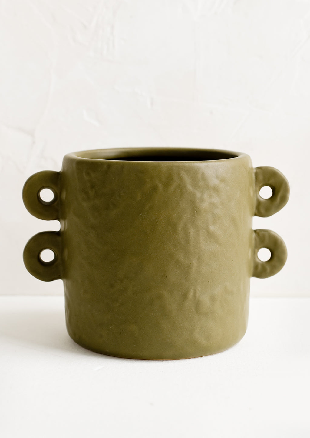 1: An army green round planter with decorative loop handles at sides.