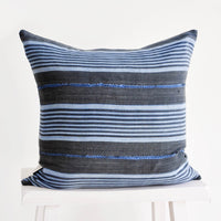 1: Square throw pillow in charcoal fabric with blue stripes throughout