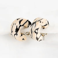 Tan Marble: A pair of small acetate hoop earrings in tan and black marble.