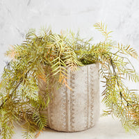 2: Distressed planter in concrete-like texture with stripe and zigzag detailing with trailing plant