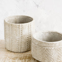 4: Distressed planters in concrete-like texture, in two different sizes with varying patterns