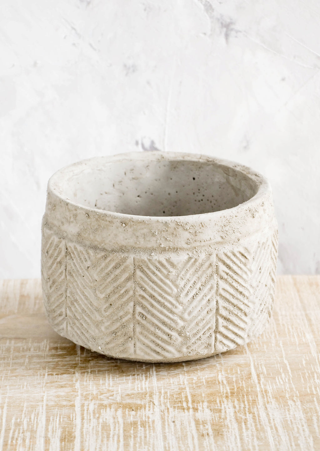 Low: Distressed planter in concrete-like texture with chevron  detailing