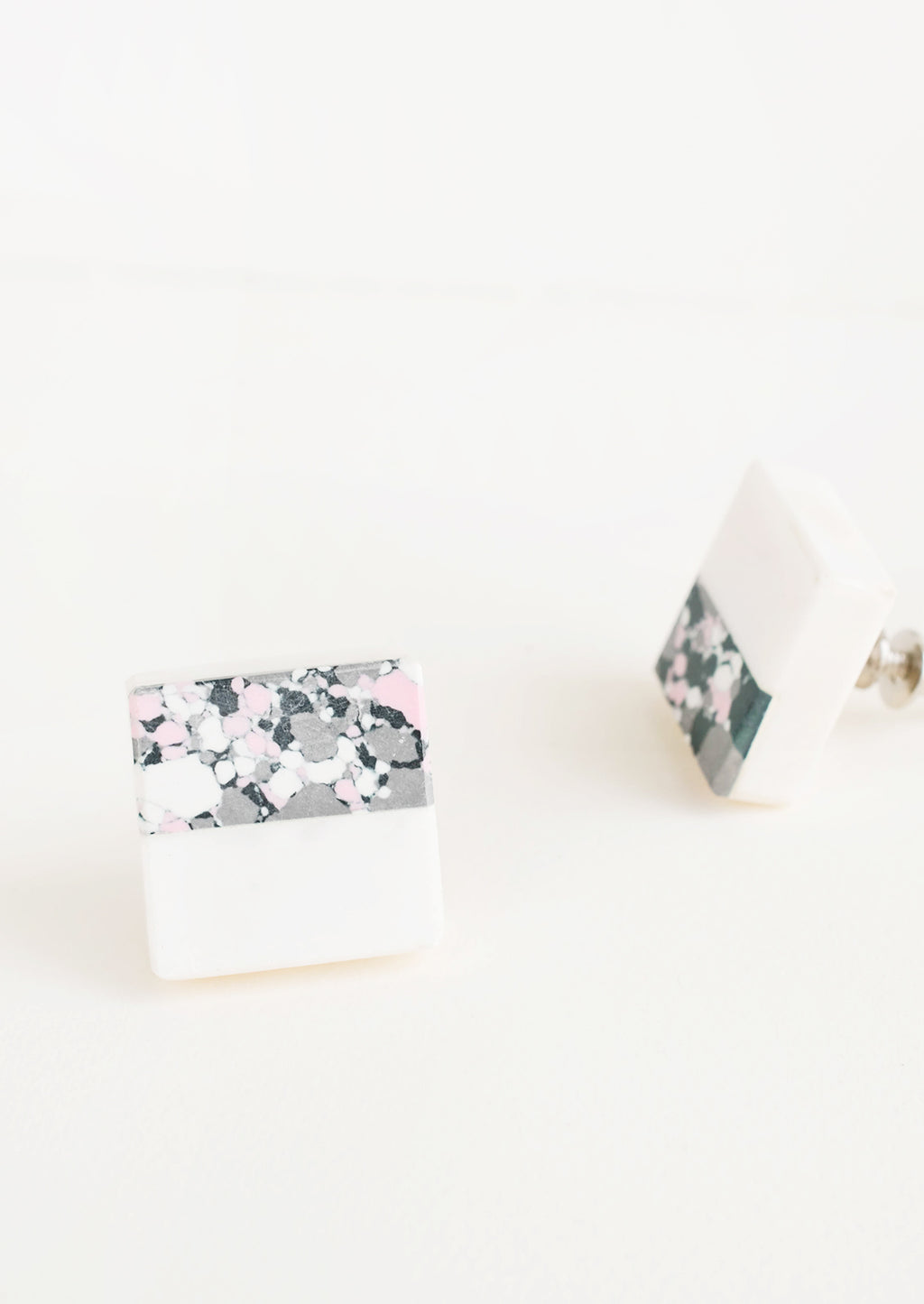 2: Square cabinet knob with white marble bottom half and splattered paint top half