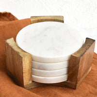 1: Set of four round, white marble coasters inside wooden stand