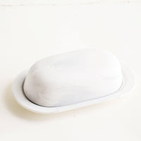 1: Oval shaped butter dish with curved dome lid, matte white ceramic with pale grey marbleized effect 