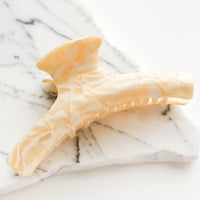 Ivory Multi: A hinged hair claw in marbled ivory and white acetate.
