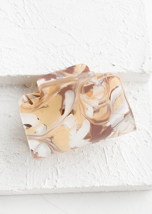 A rectangular acetate hair clip in marbleized taupe.