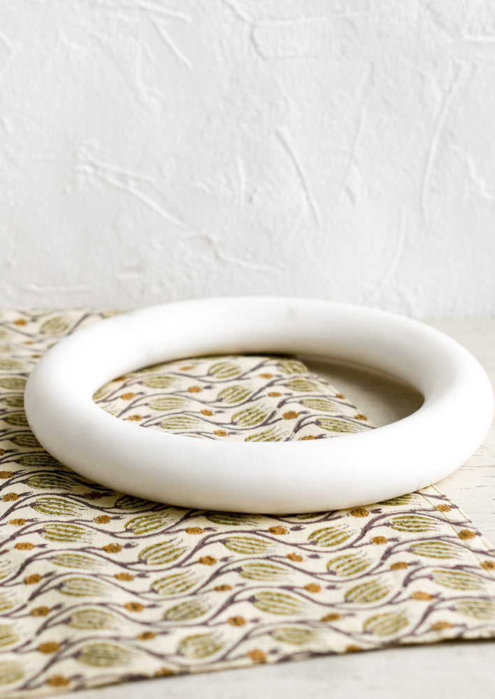 3: A circular shaped trivet in solid marble.