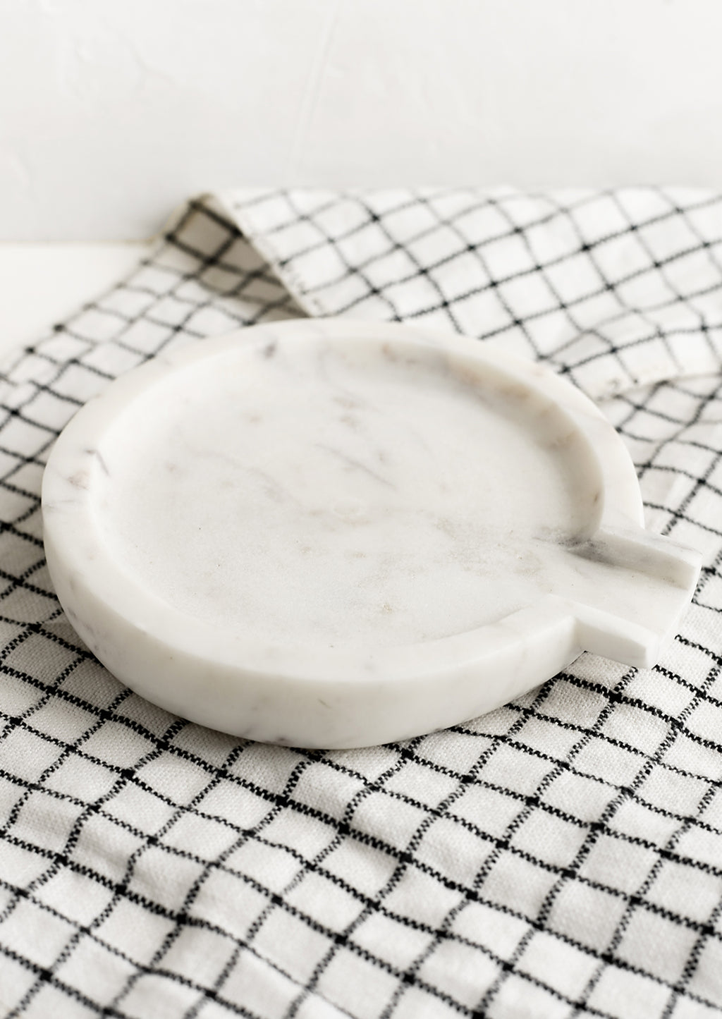 2: A round white marble spoon rest.