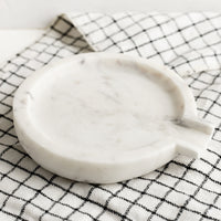 2: A round white marble spoon rest.
