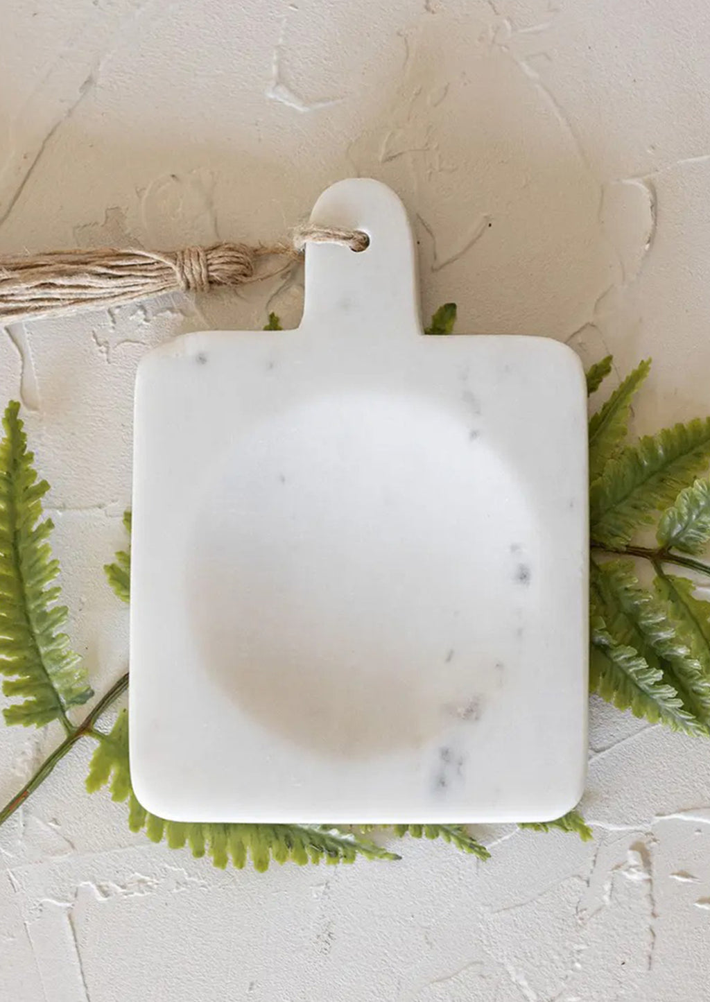 White Marble: A paddle shaped spoon rest with center well in white marble.