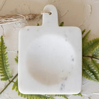 White Marble: A paddle shaped spoon rest with center well in white marble.