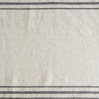 2: A linen table runner with stripes at sides.
