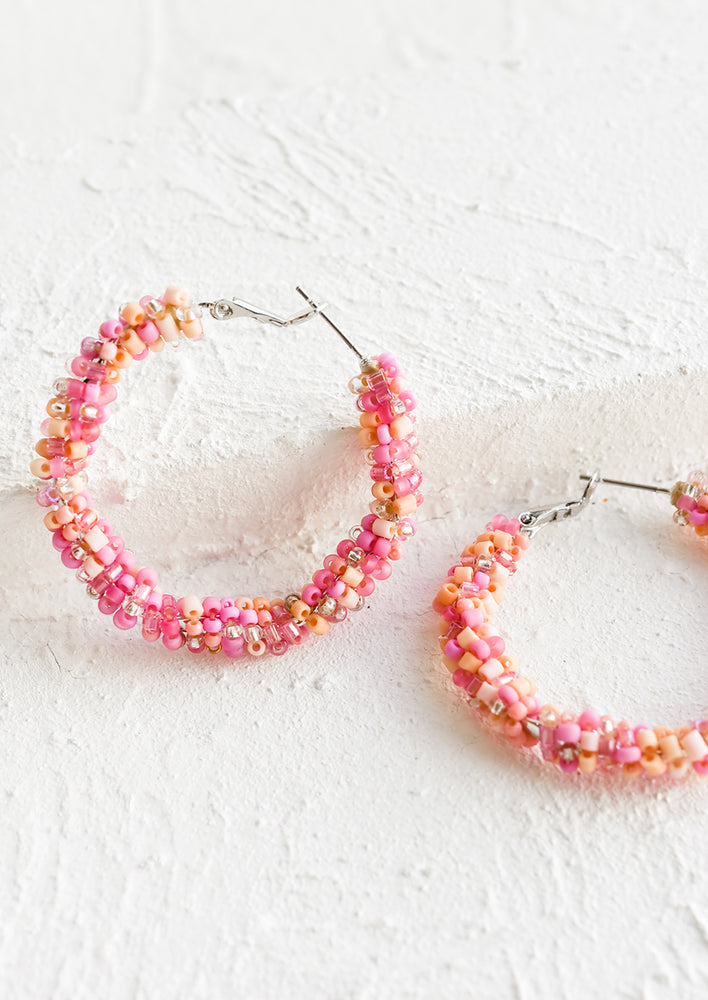 1: Beaded hoop earrings in pink and orange.