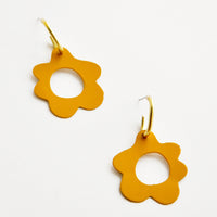 Saffron: Mustard yellow flower shaped earrings with circular cutouts on small brass open hoops.