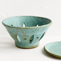 3: A ceramic berry bowl with plate in turquoise.