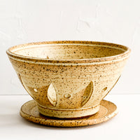 Buttermilk Speckle: A ceramic berry bowl with plate in yellow speckle.