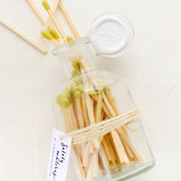 Citron: Safety matches with lime green tips in a vintage-style glass apothecary jar with white wax seal on lid.