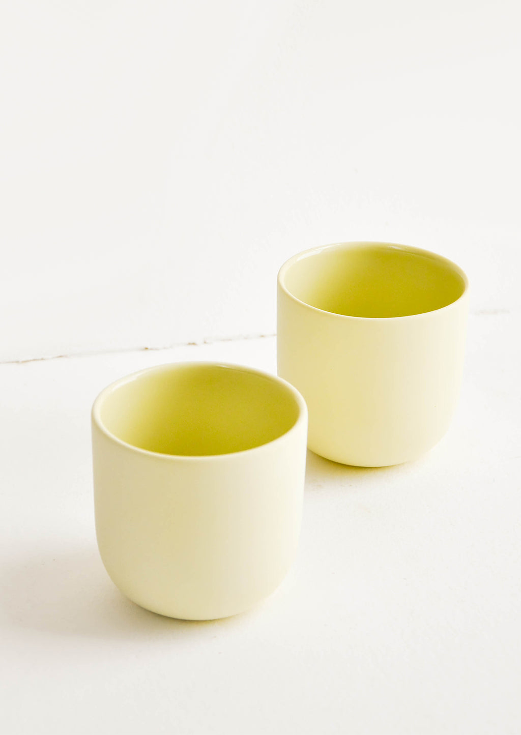Citron: Two yellow matte porcelain short tumblers.