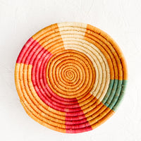 1: Woven raffia bowl in mustard, pink, natural and turquoise geometric pattern