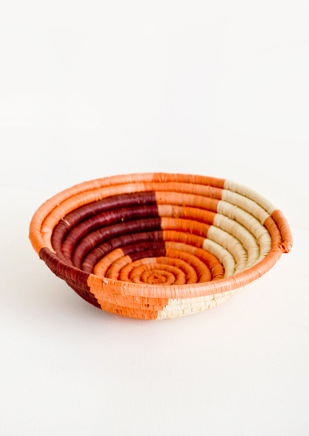 Coral / Wine Multi: Small raffia bowl in geometric pattern in coral, wine and natural