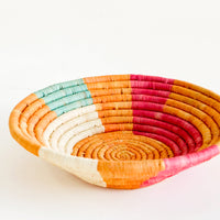 2: Shallow raffia bowl in mustard, pink, natural and turquoise geometric pattern
