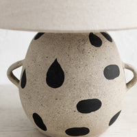 2: A ceramic table lamp with dot print and side handles on base, with tapered linen shade.