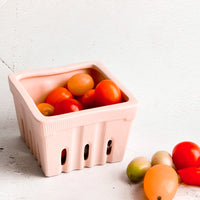 Blush: Ceramic basket in the style of disposable berry basket, displayed with cherry tomatoes