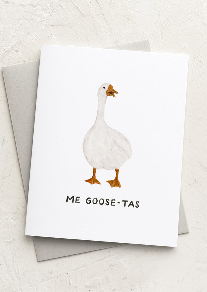 A greeting card with image of goose and text reading "Me goose-tas".