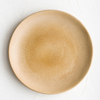 1: A round ceramic dinner plate in matte chocolate brown glaze.