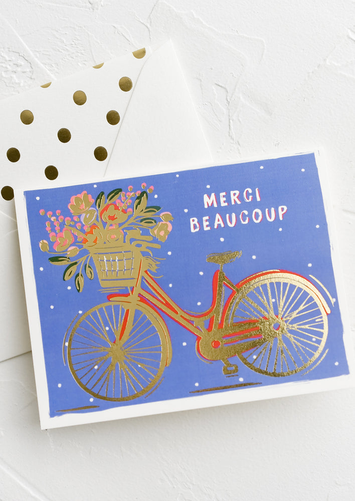 1: A greeting card with picture of bicycle and text reading Merci Beaucoup.