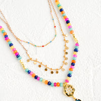 1: Triple strand layered necklace with beaded outer strand and gold inner strands.
