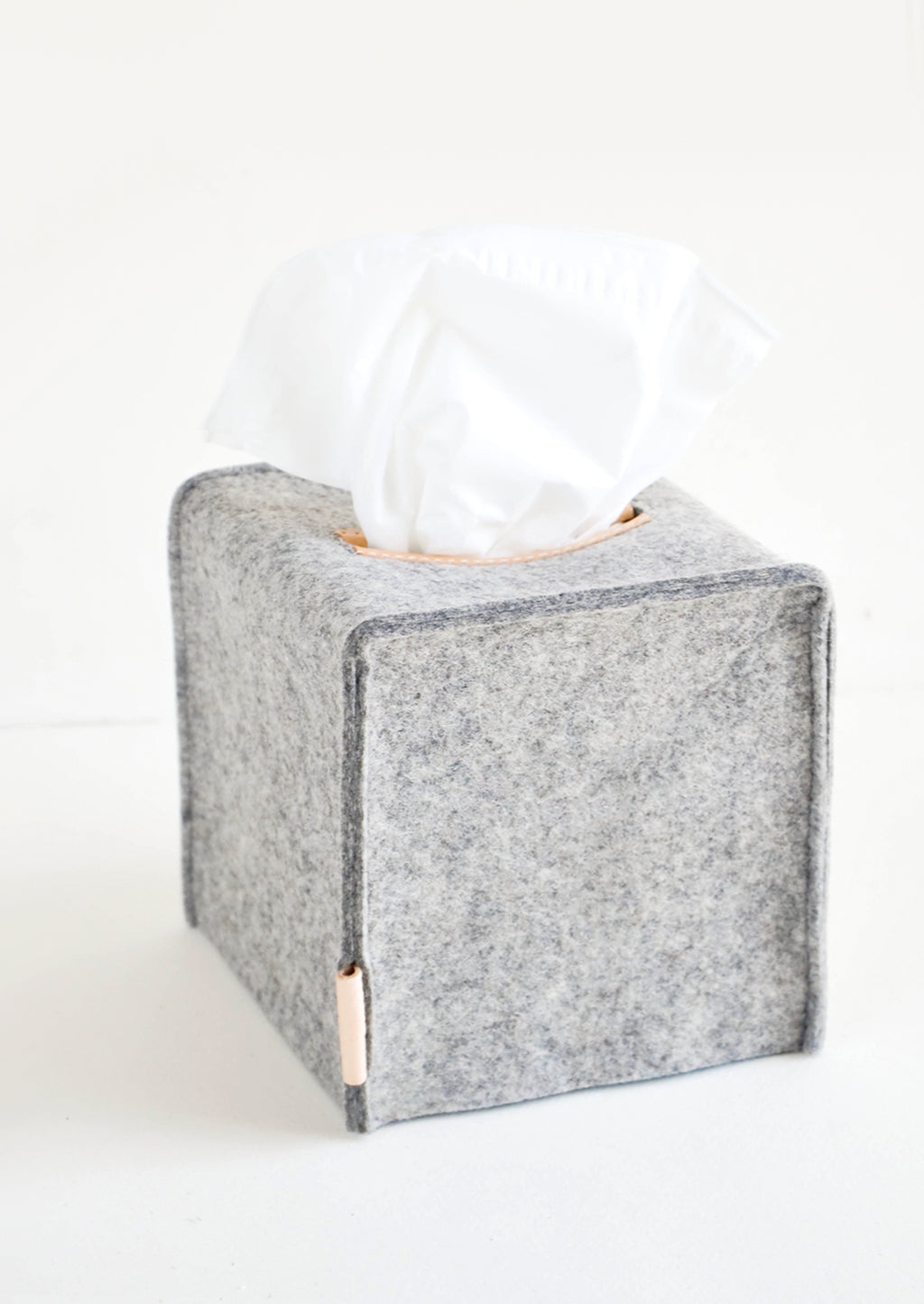 Cube / Granite: Cube-shaped tissue box cover made from felted wool in heathered dark grey color with leather accents