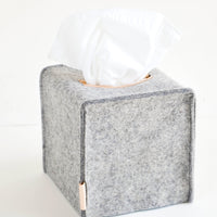 Cube / Granite: Cube-shaped tissue box cover made from felted wool in heathered dark grey color with leather accents