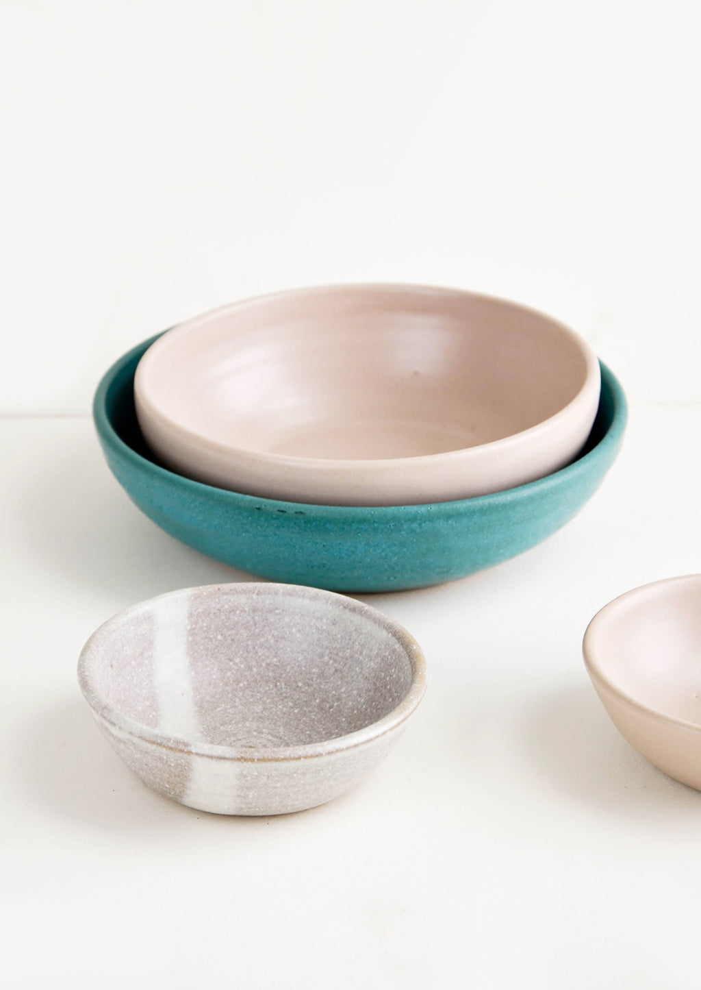 2: Grouping of handmade ceramic bowls in a mix of colors and sizes