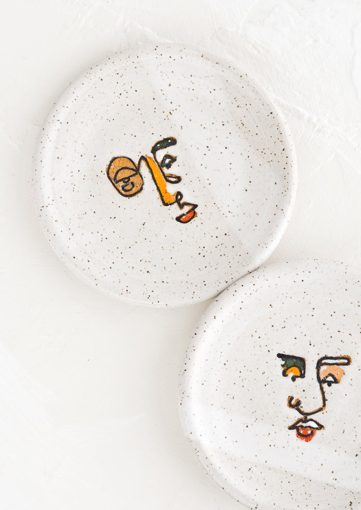 3: Two small speckled ceramic trinket dishes with and painted expressionist faces.