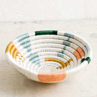 2: A small catchall bowl made from sweetgrass in pastel colored geometric pattern.