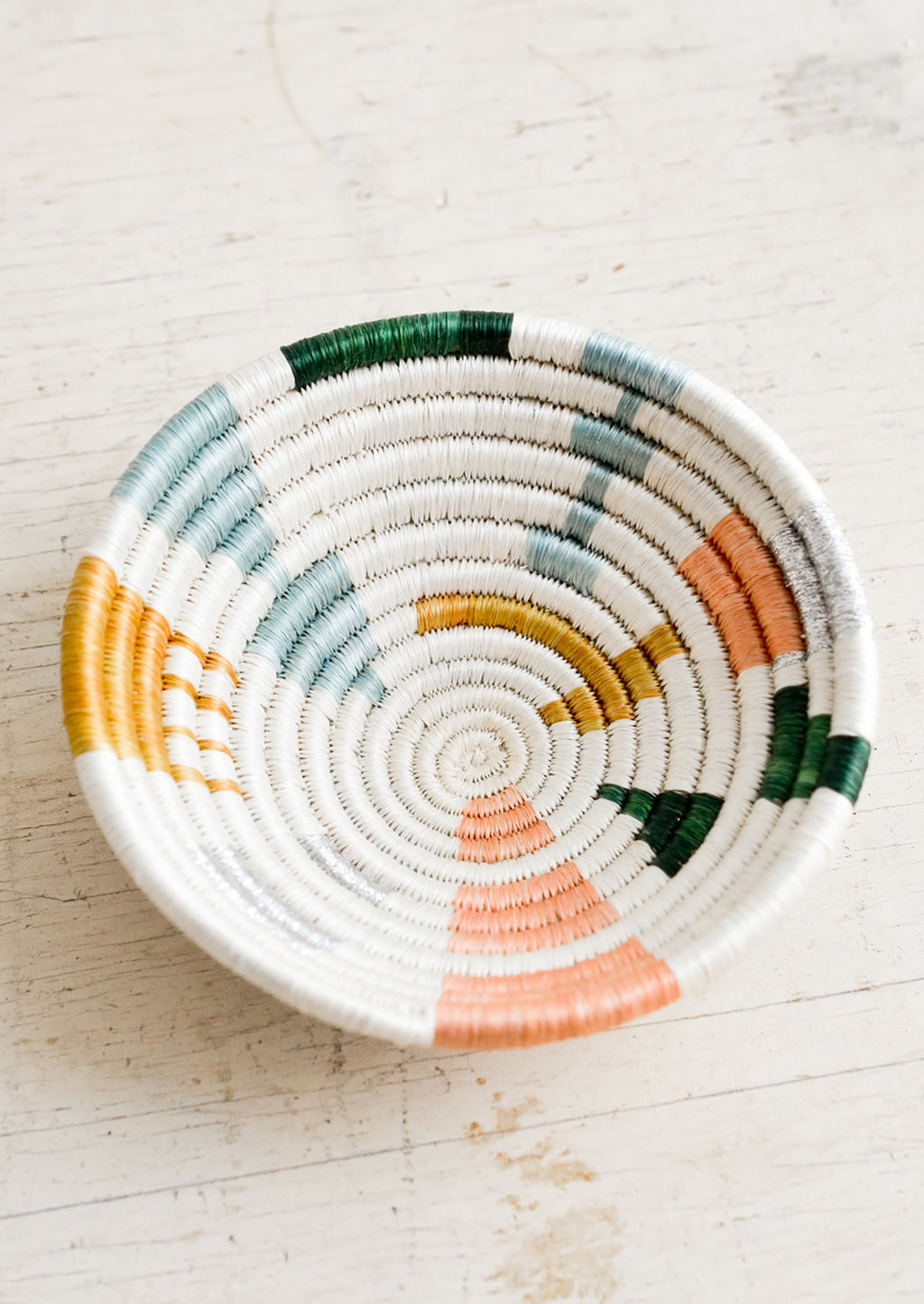 1: A small catchall bowl made from sweetgrass in pastel colored geometric pattern.